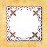 Decorative napkin with purple and gold patterns.